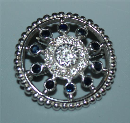 A 1970s platinum and gem set circular brooch, 1in.